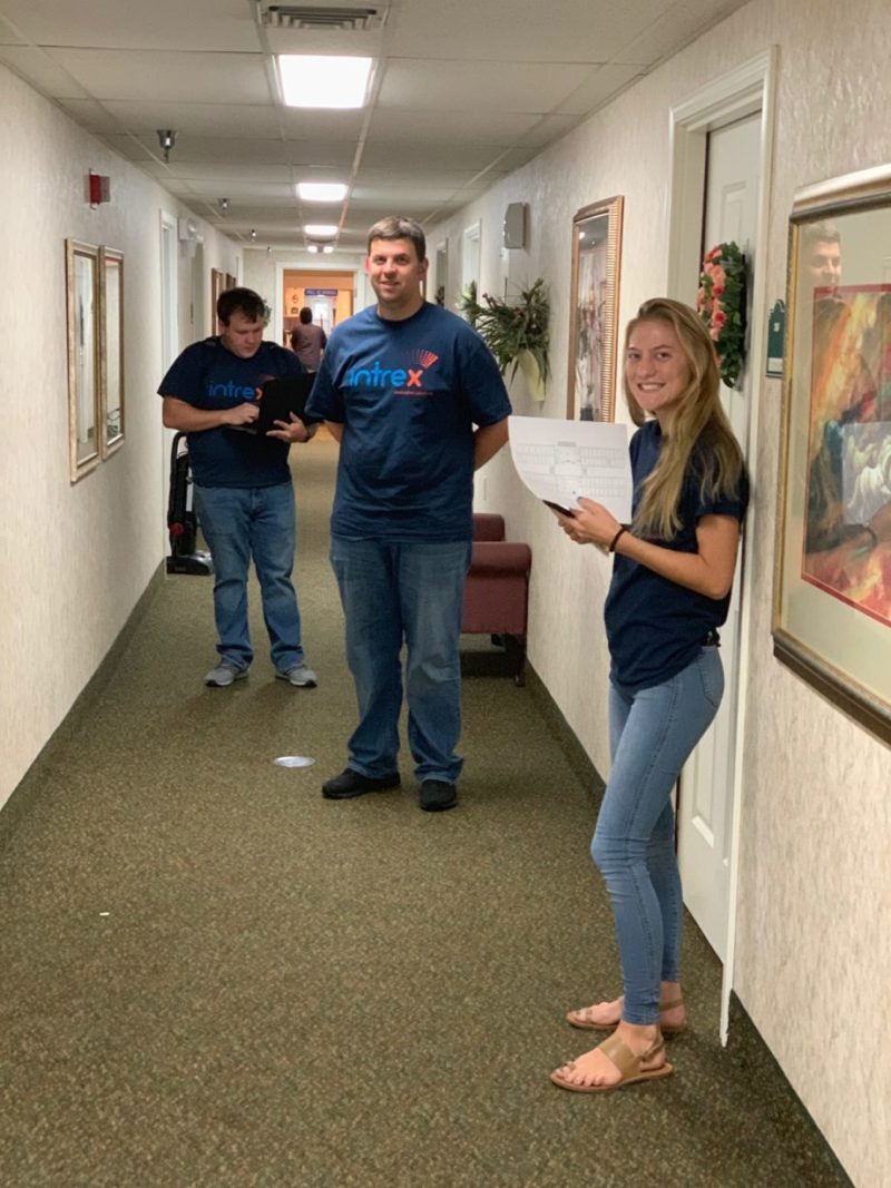 1 male and 1 female Intrex employee smiling at a senior living community